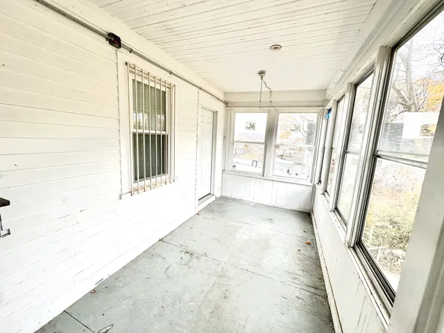 a view of a bathroom with wooden floor and a window