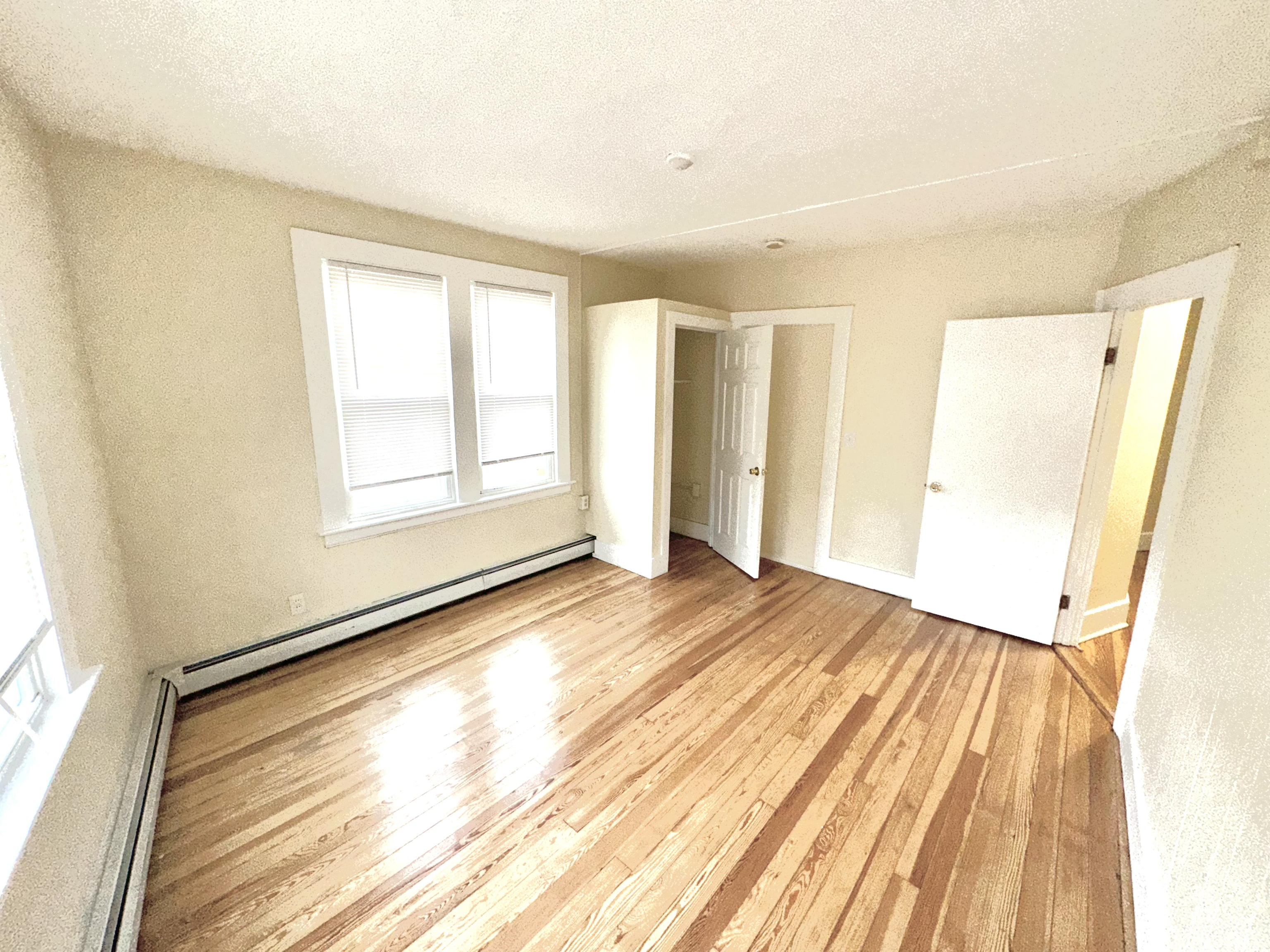 1019 West Main Street, Unit 3L Waterbury, CT 06708 - Photo 3 of 29 a view of empty room with wooden floor and fan
