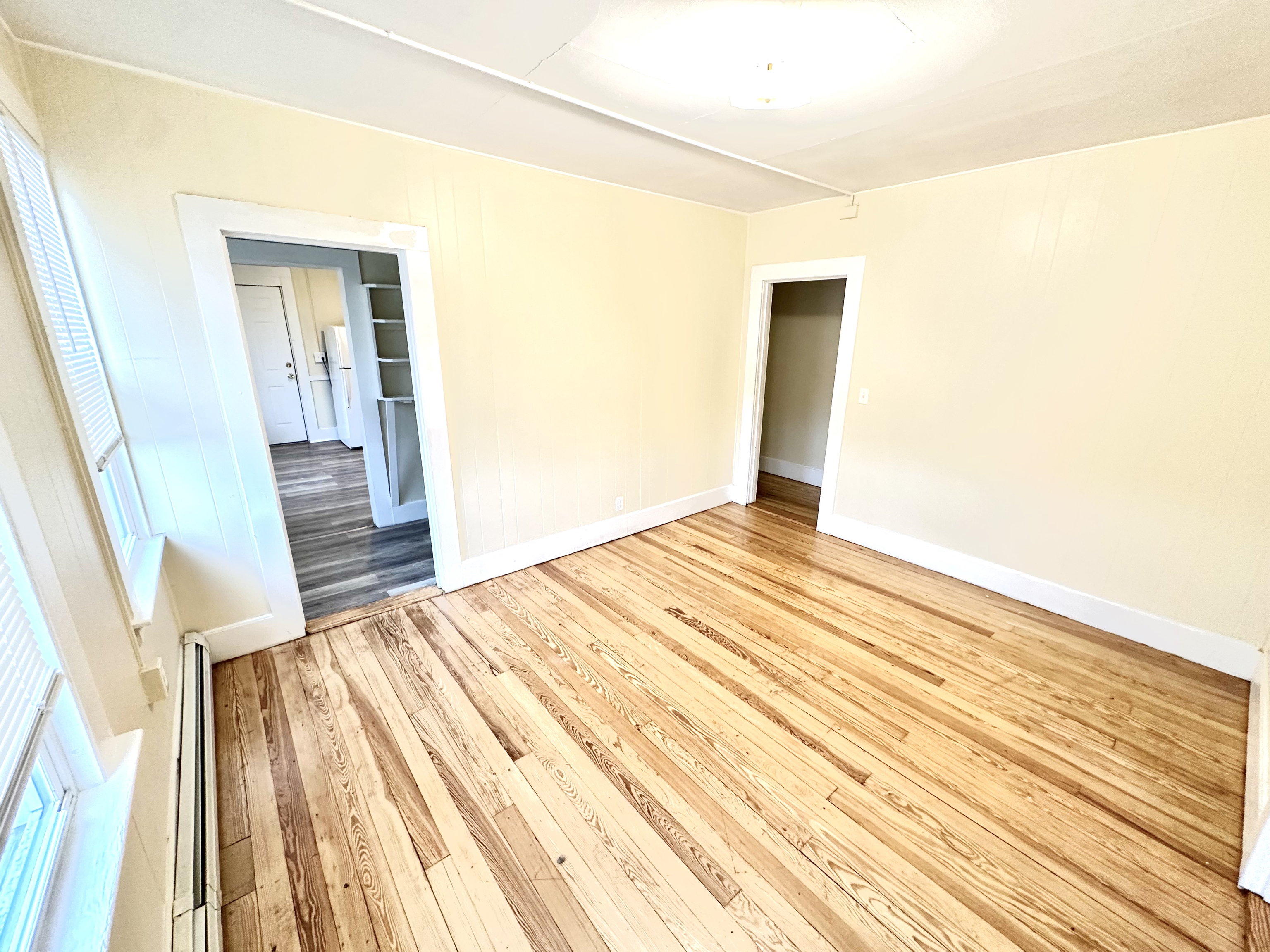 1019 West Main Street, Unit 3L Waterbury, CT 06708 - Photo 6 of 29 a bedroom with a bed and wooden floor