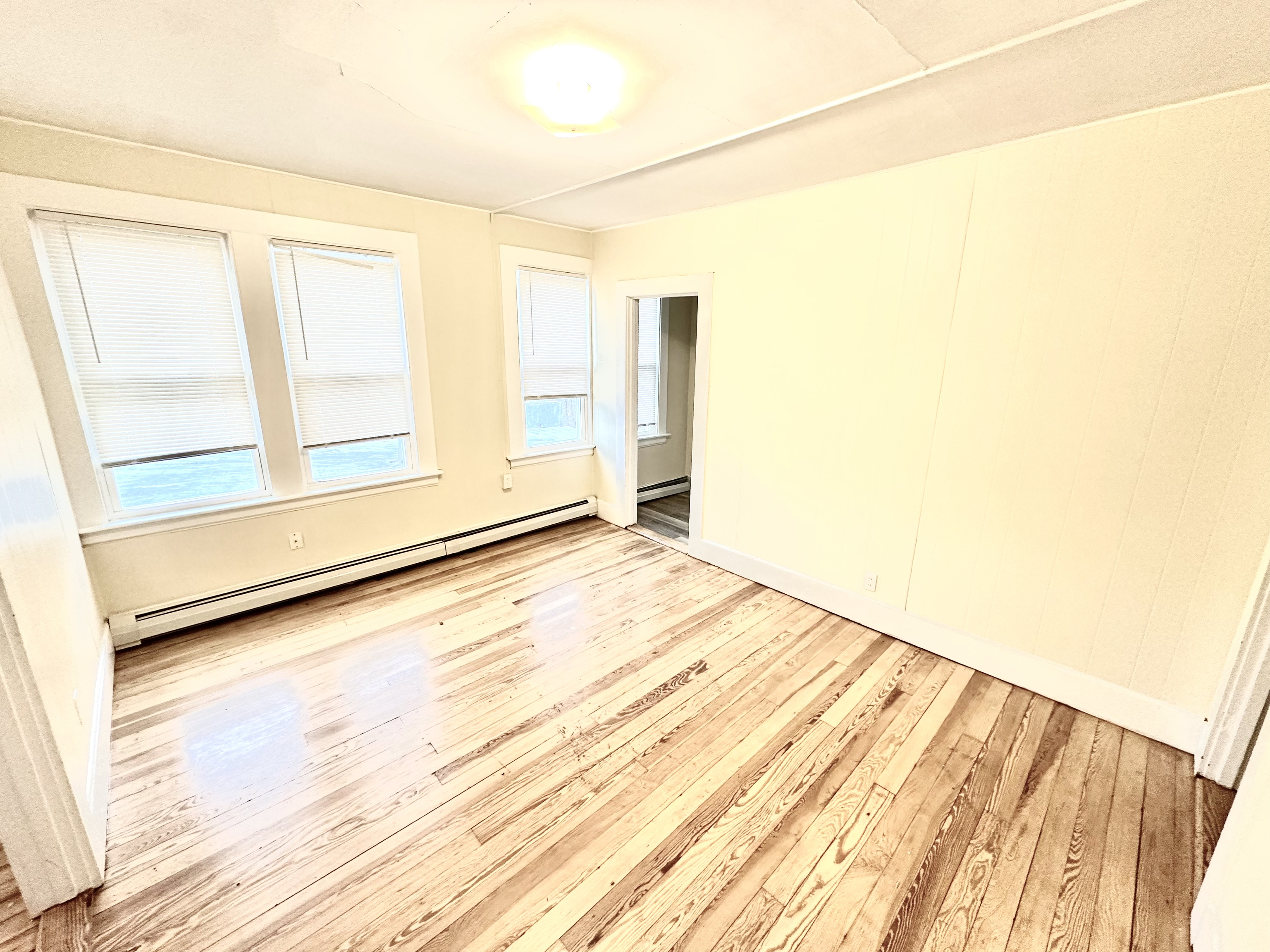 1019 West Main Street, Unit 3L Waterbury, CT 06708 - Photo 8 of 29 a view of a room with wooden floor and white walls