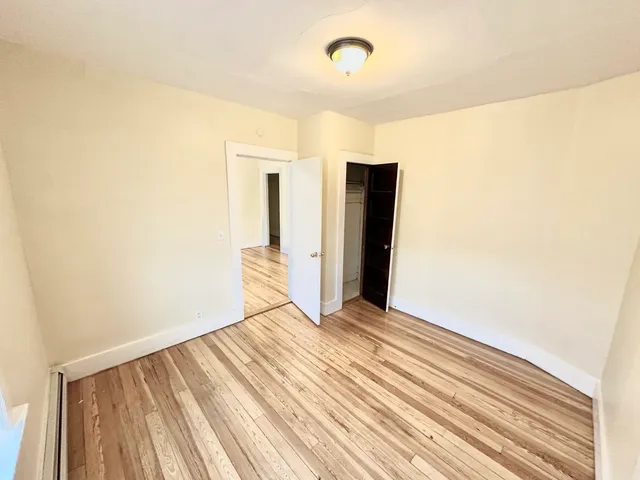 a view of a room with wooden floor