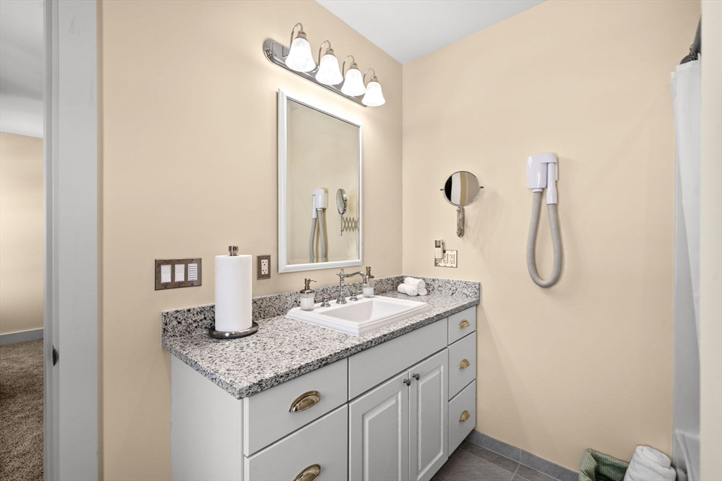 72 Dale Lane Groton, MA 01450 - Photo 24 of 42 a bathroom with a granite countertop sink and a mirror