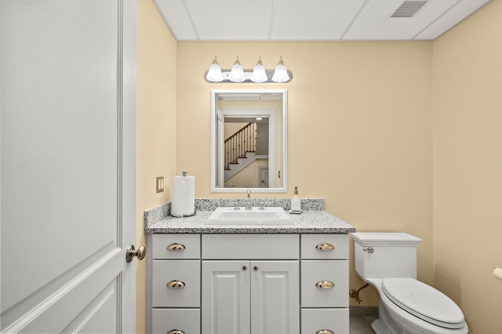 72 Dale Lane Groton, MA 01450 - Photo 28 of 42 a bathroom with a sink vanity mirror and toilet
