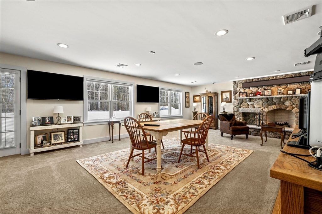 72 Dale Lane Groton, MA 01450 - Photo 32 of 42 a living room with furniture and a flat screen tv