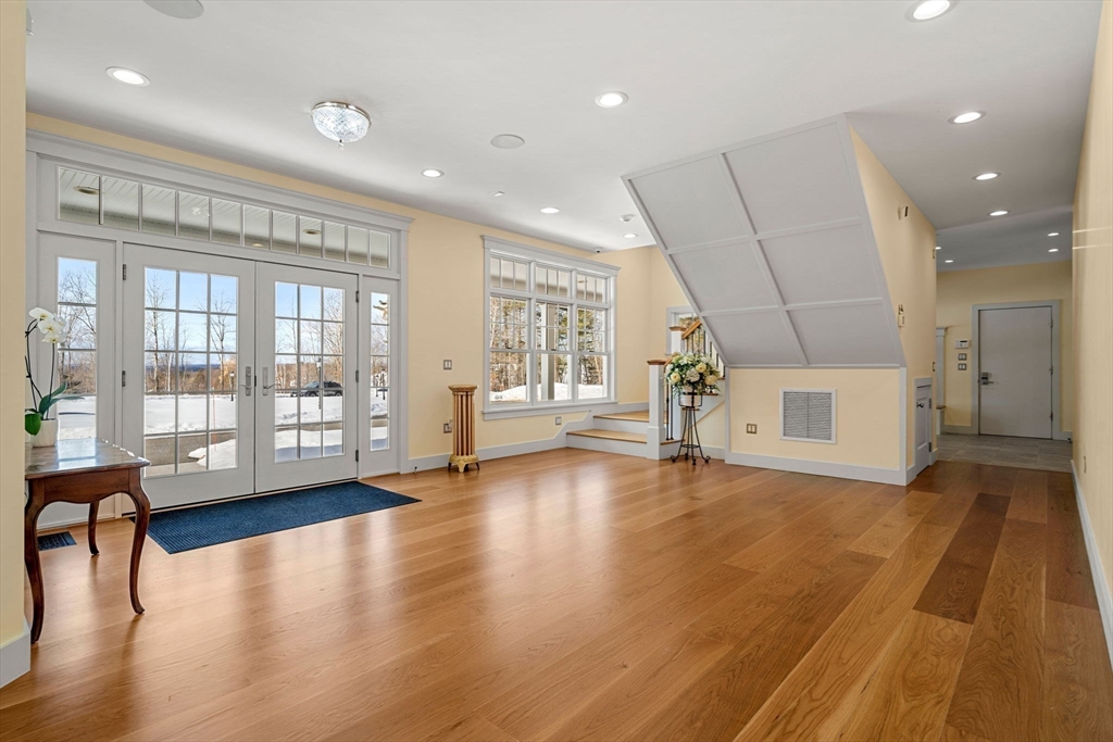 72 Dale Lane Groton, MA 01450 - Photo 7 of 42 a view of an empty room with a window and wooden floor