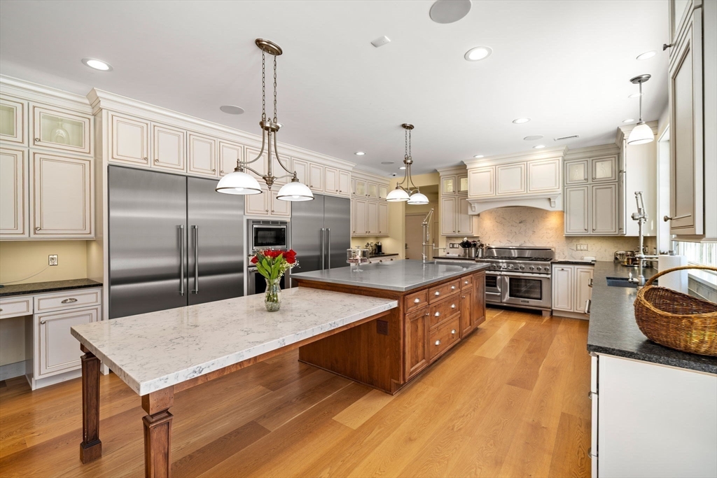 72 Dale Lane Groton, MA 01450 - Photo 10 of 42 a kitchen with stainless steel appliances kitchen island granite countertop a sink a counter space and stainless steel appliances