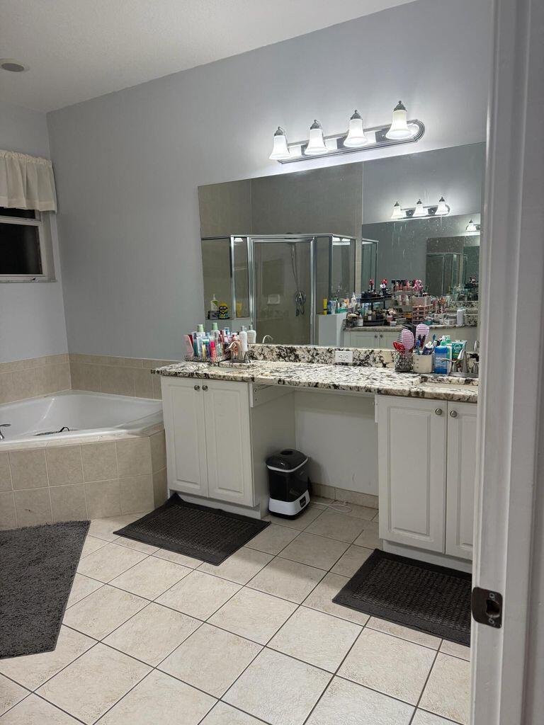 2891 Cedar Dunes Drive Port St. Lucie, FL 34953 - Photo 14 of 25 a bathroom with a sink a vanity and mirror