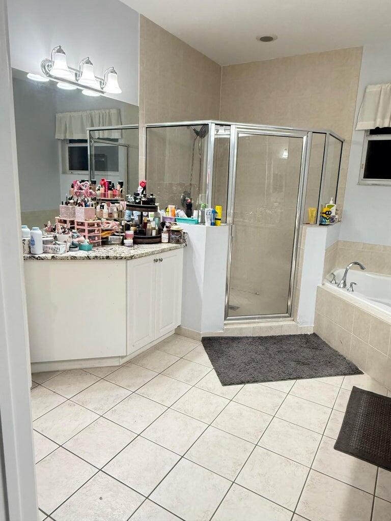 2891 Cedar Dunes Drive Port St. Lucie, FL 34953 - Photo 15 of 25 a kitchen with a sink and refrigerator