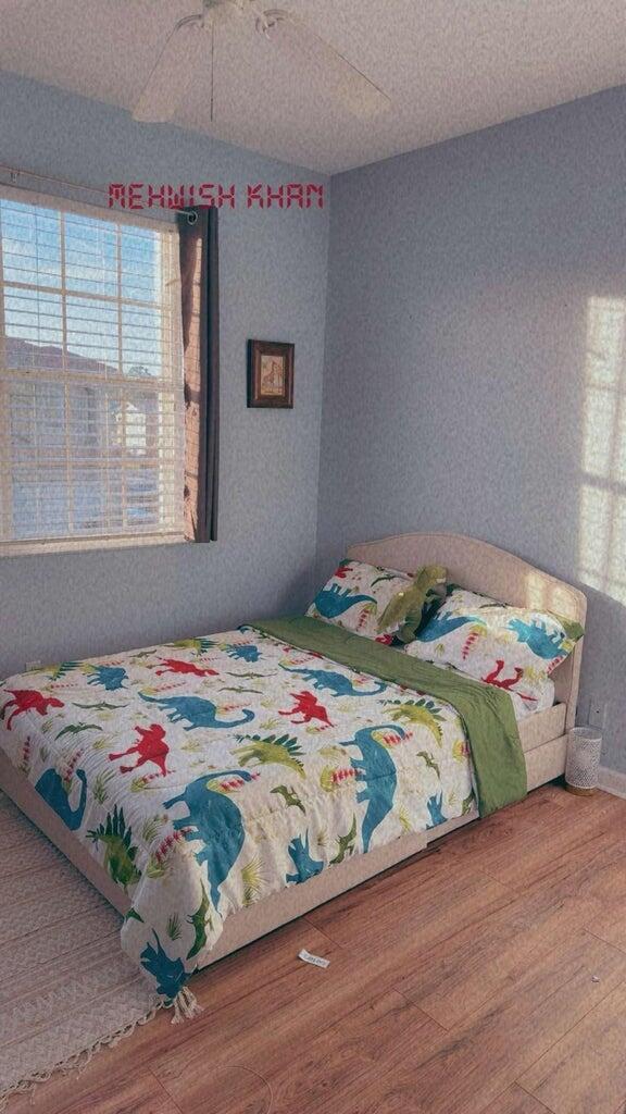 2891 Cedar Dunes Drive Port St. Lucie, FL 34953 - Photo 17 of 25 a bedroom with a bed and a window