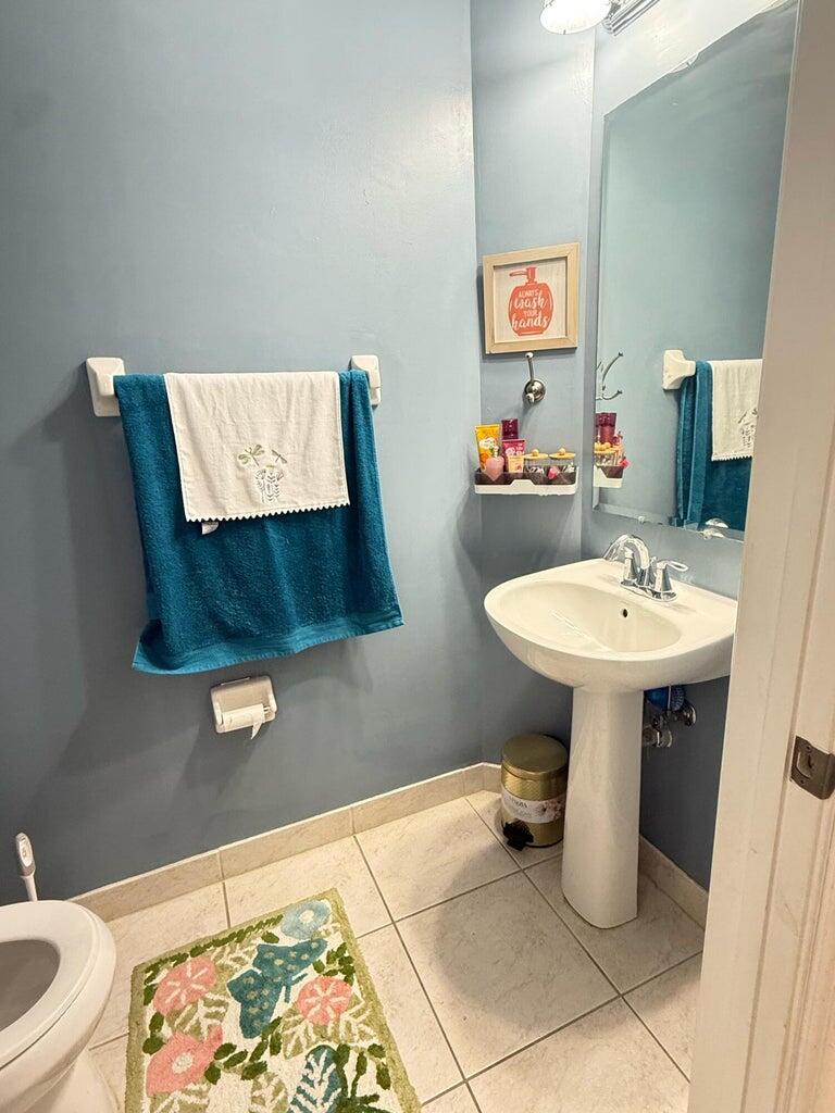 2891 Cedar Dunes Drive Port St. Lucie, FL 34953 - Photo 20 of 25 a bathroom with a sink toilet and mirror