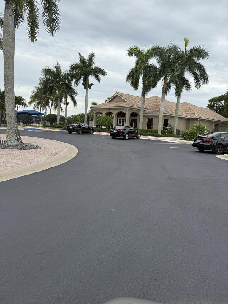2891 Cedar Dunes Drive Port St. Lucie, FL 34953 - Photo 25 of 25 a couple of palm trees sitting in front of a building