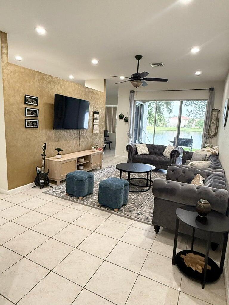 2891 Cedar Dunes Drive Port St. Lucie, FL 34953 - Photo 4 of 25 a living room with furniture and a flat screen tv