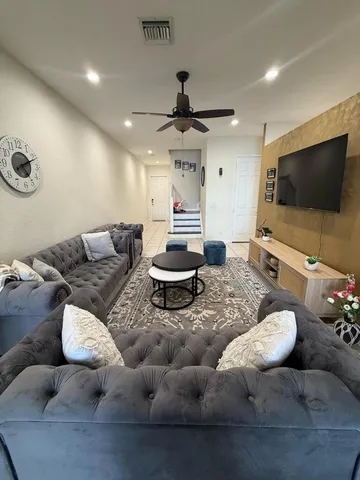 a living room with furniture and a large window