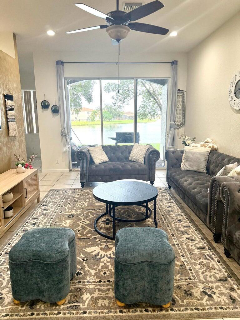 2891 Cedar Dunes Drive Port St. Lucie, FL 34953 - Photo 6 of 25 a living room with furniture and a large window
