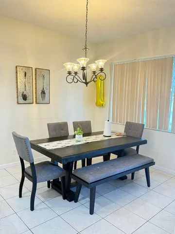 a kitchen with granite countertop a refrigerator and a stove top oven