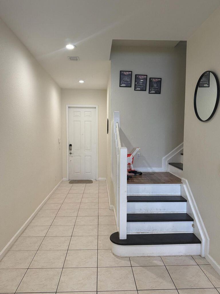 2891 Cedar Dunes Drive Port St. Lucie, FL 34953 - Photo 10 of 25 a view of an entryway with staircase