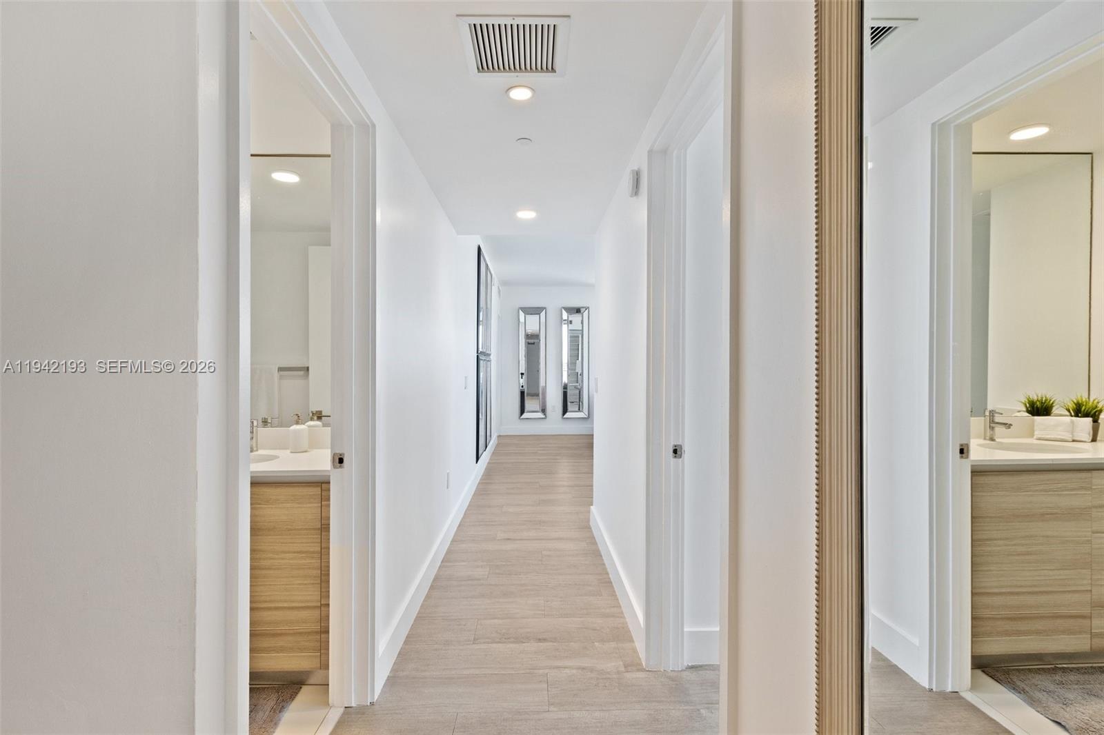 121 Northeast 34th Street, Unit 1008 Miami, FL 33137 - Photo 11 of 52 a view of a hallway with wooden floor and staircase