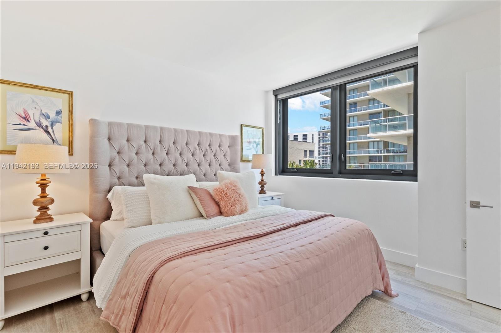 121 Northeast 34th Street, Unit 1008 Miami, FL 33137 - Photo 13 of 52 a bedroom with a large bed and a large window