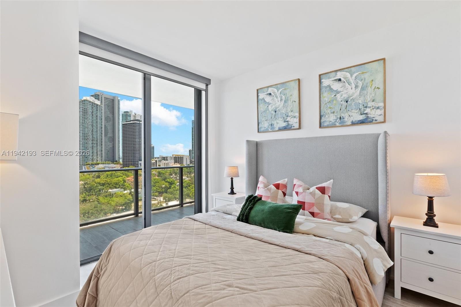 121 Northeast 34th Street, Unit 1008 Miami, FL 33137 - Photo 16 of 52 a bedroom with a large bed and a window