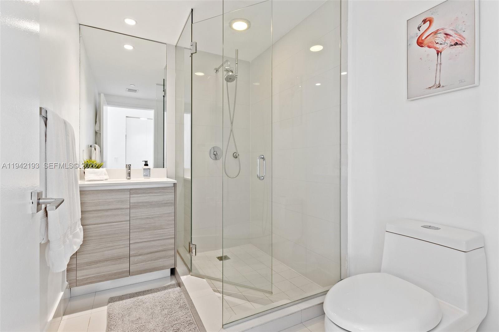 121 Northeast 34th Street, Unit 1008 Miami, FL 33137 - Photo 18 of 52 a bathroom with a shower toilet and sink