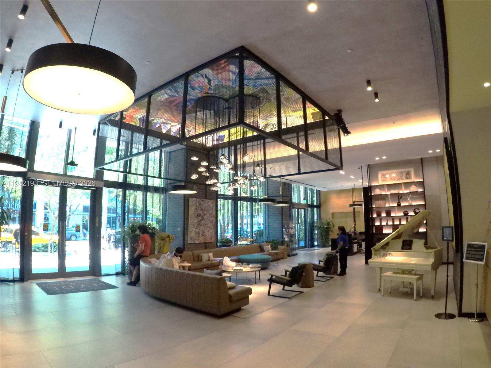 121 Northeast 34th Street, Unit 1008 Miami, FL 33137 - Photo 29 of 52 a living room with furniture and a large window