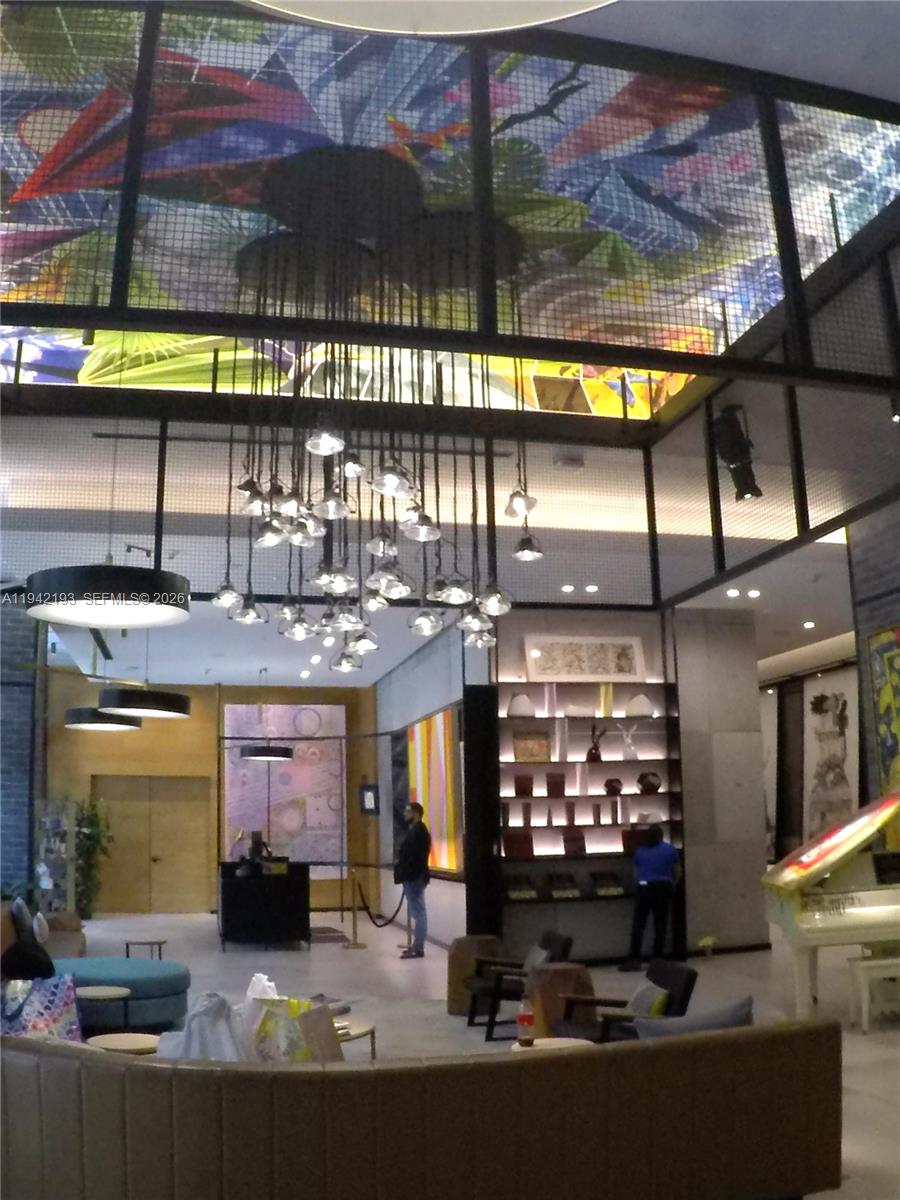 121 Northeast 34th Street, Unit 1008 Miami, FL 33137 - Photo 30 of 52 a view of a chairs and a table in the balcony