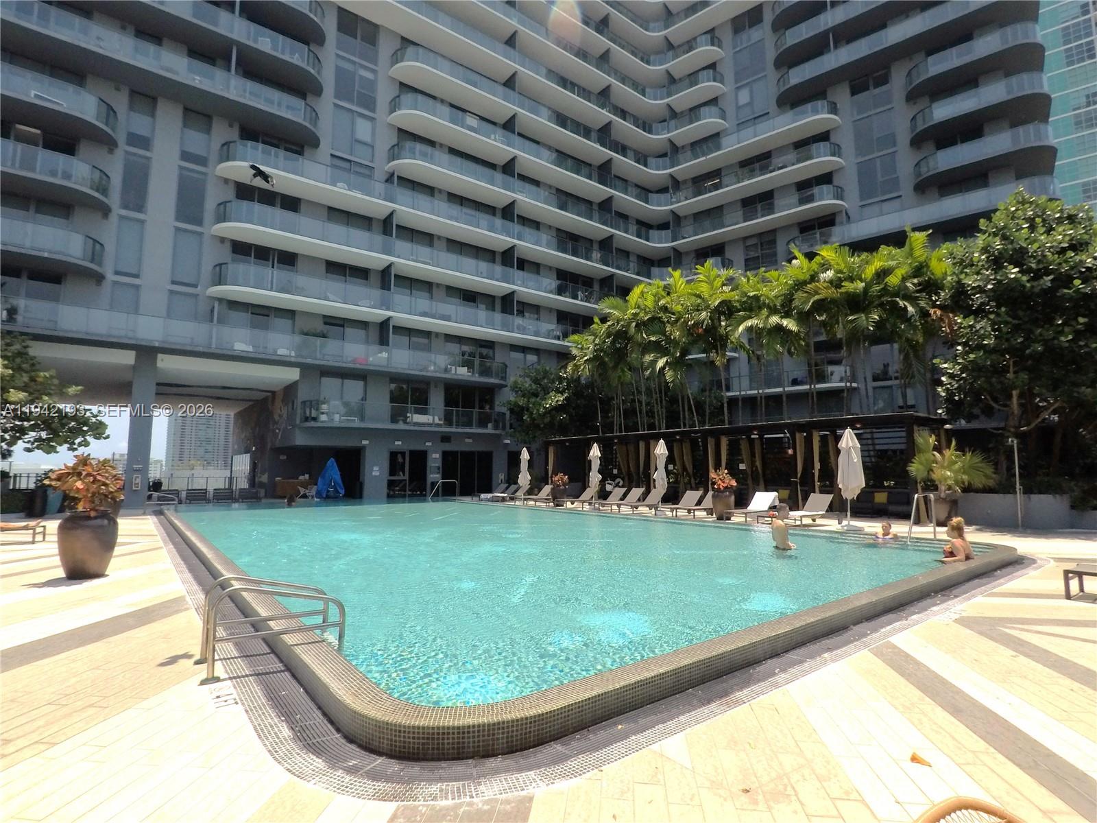 121 Northeast 34th Street, Unit 1008 Miami, FL 33137 - Photo 33 of 52 a view of a swimming pool with sitting area