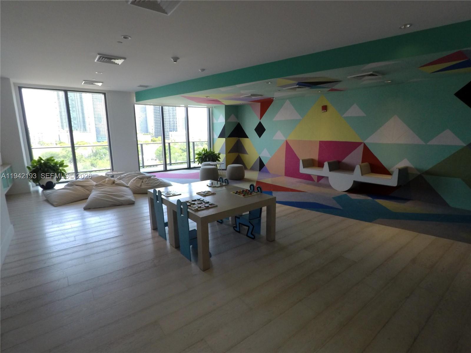 121 Northeast 34th Street, Unit 1008 Miami, FL 33137 - Photo 34 of 52 a living room with furniture and wooden floor