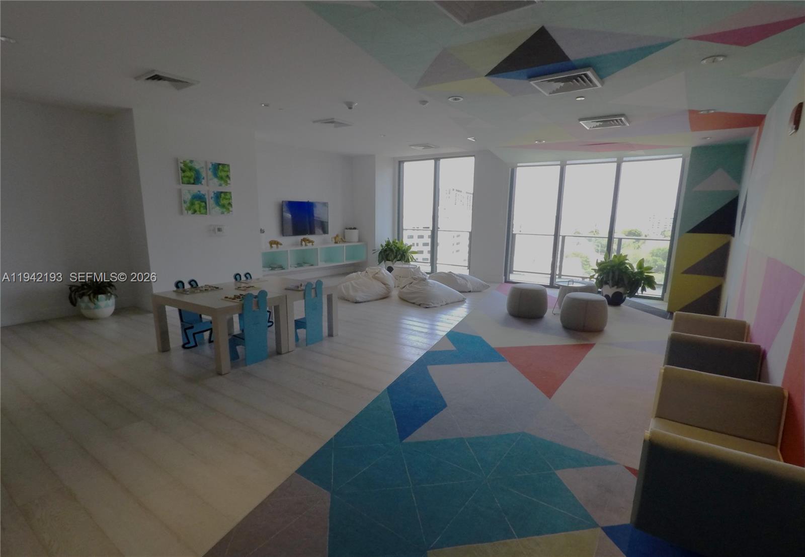 121 Northeast 34th Street, Unit 1008 Miami, FL 33137 - Photo 35 of 52 a living room with furniture and a flat screen tv