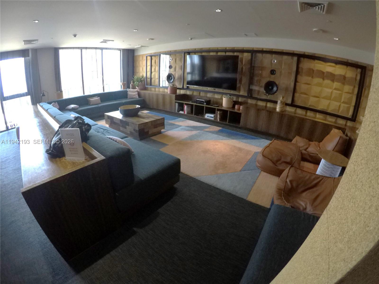 121 Northeast 34th Street, Unit 1008 Miami, FL 33137 - Photo 36 of 52 a living room with furniture and a flat screen tv