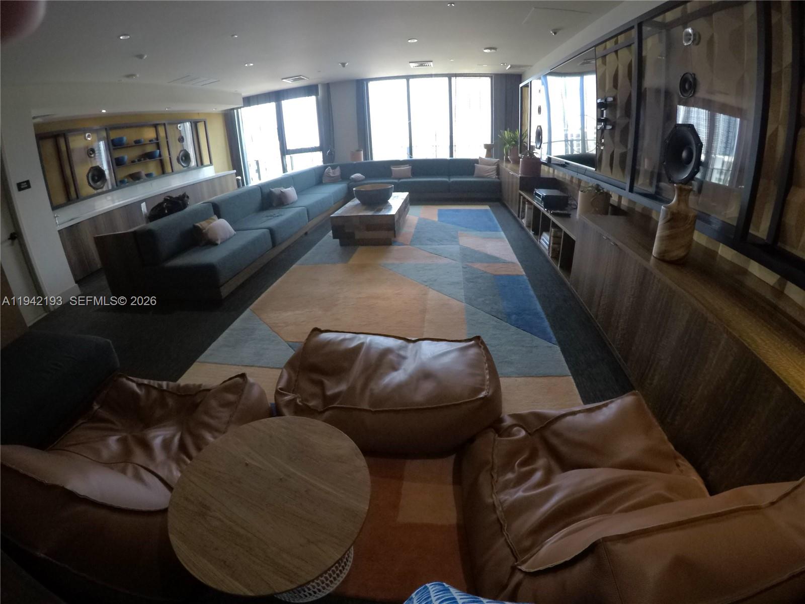 121 Northeast 34th Street, Unit 1008 Miami, FL 33137 - Photo 37 of 52 a living room with furniture and a flat screen tv