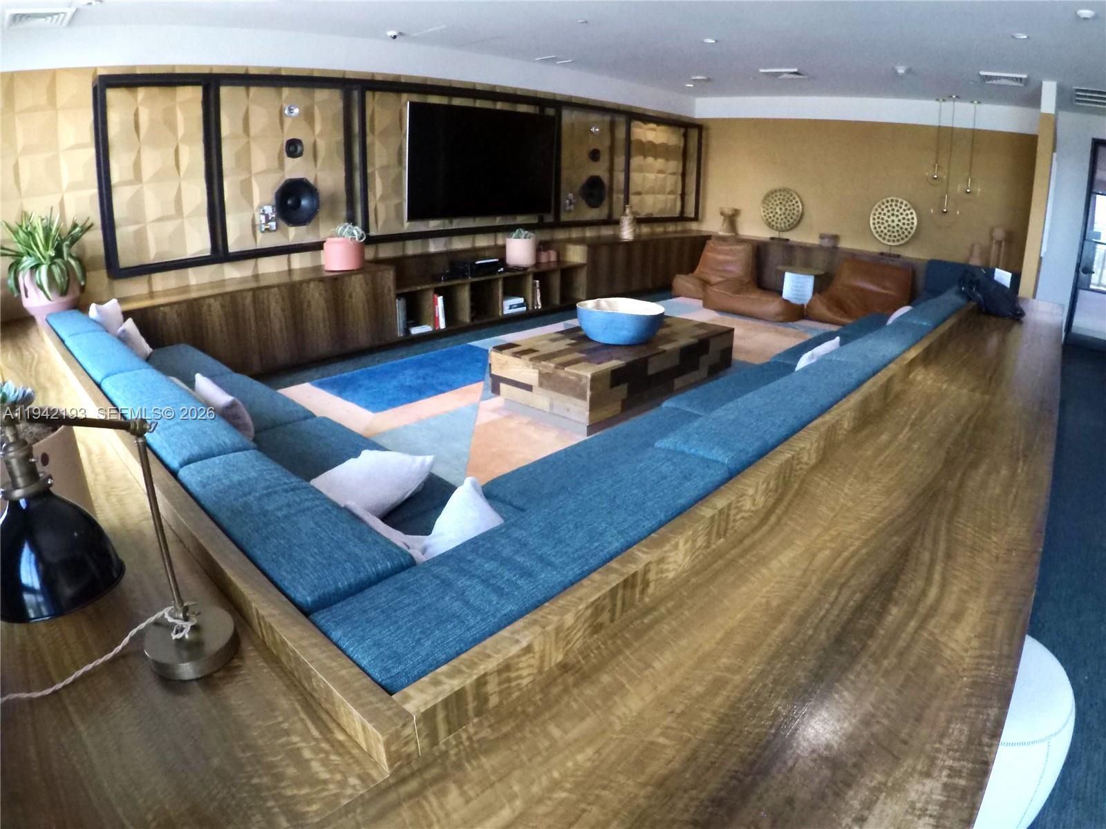 121 Northeast 34th Street, Unit 1008 Miami, FL 33137 - Photo 39 of 52 a living room with furniture and a flat screen tv