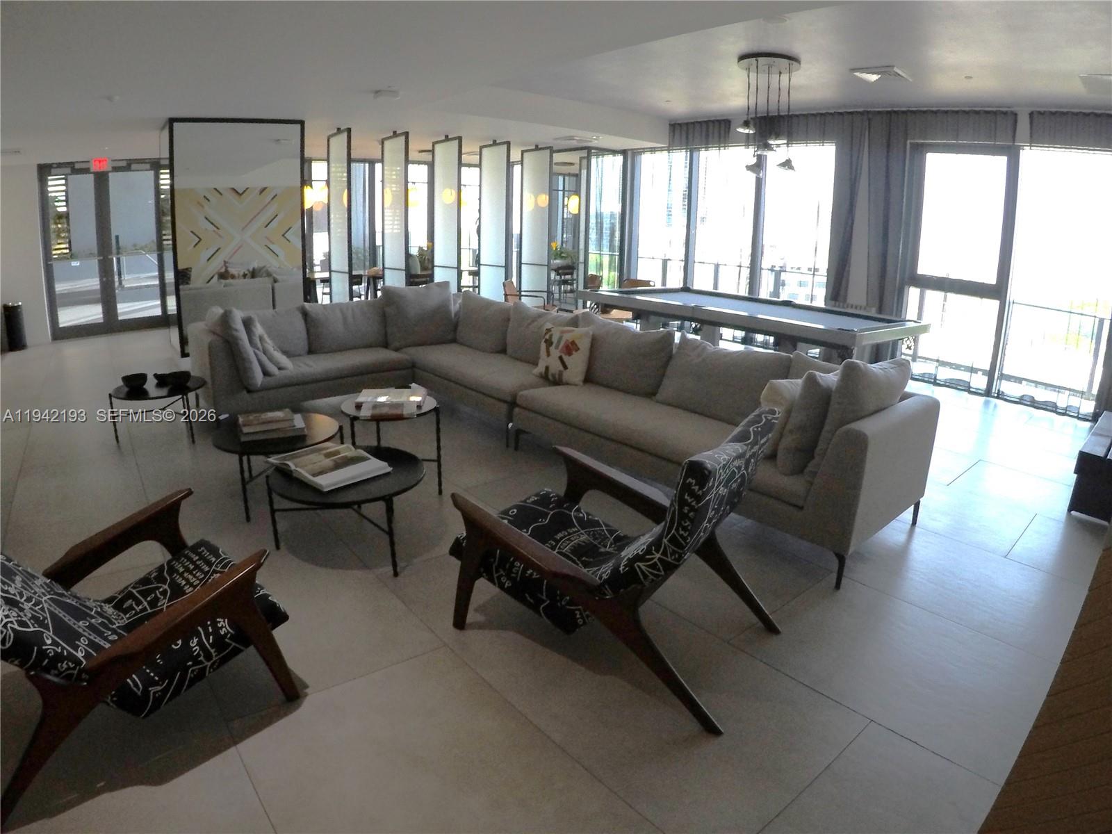 121 Northeast 34th Street, Unit 1008 Miami, FL 33137 - Photo 40 of 52 a living room with furniture and a large window