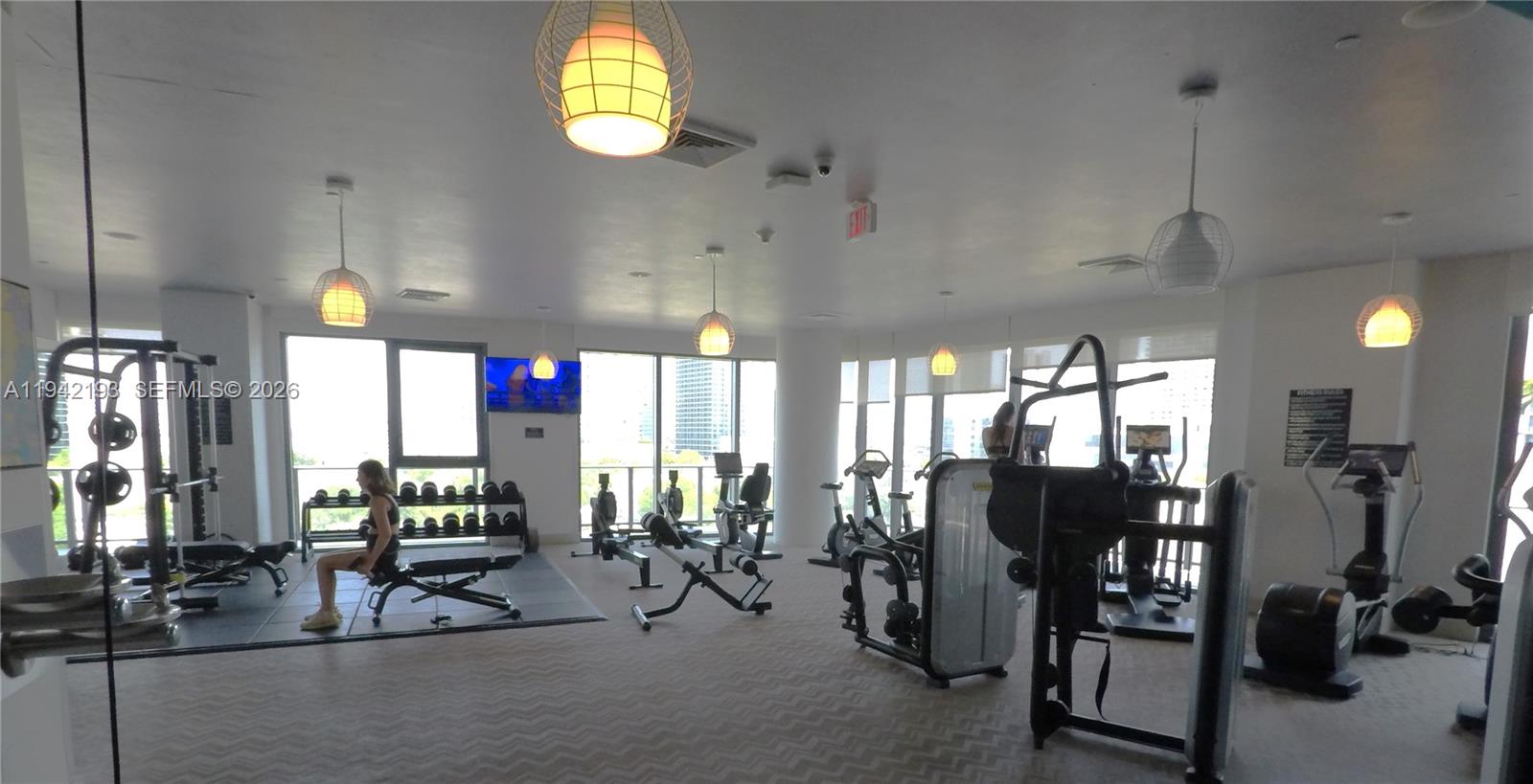 121 Northeast 34th Street, Unit 1008 Miami, FL 33137 - Photo 42 of 52 a view of a room with gym equipment