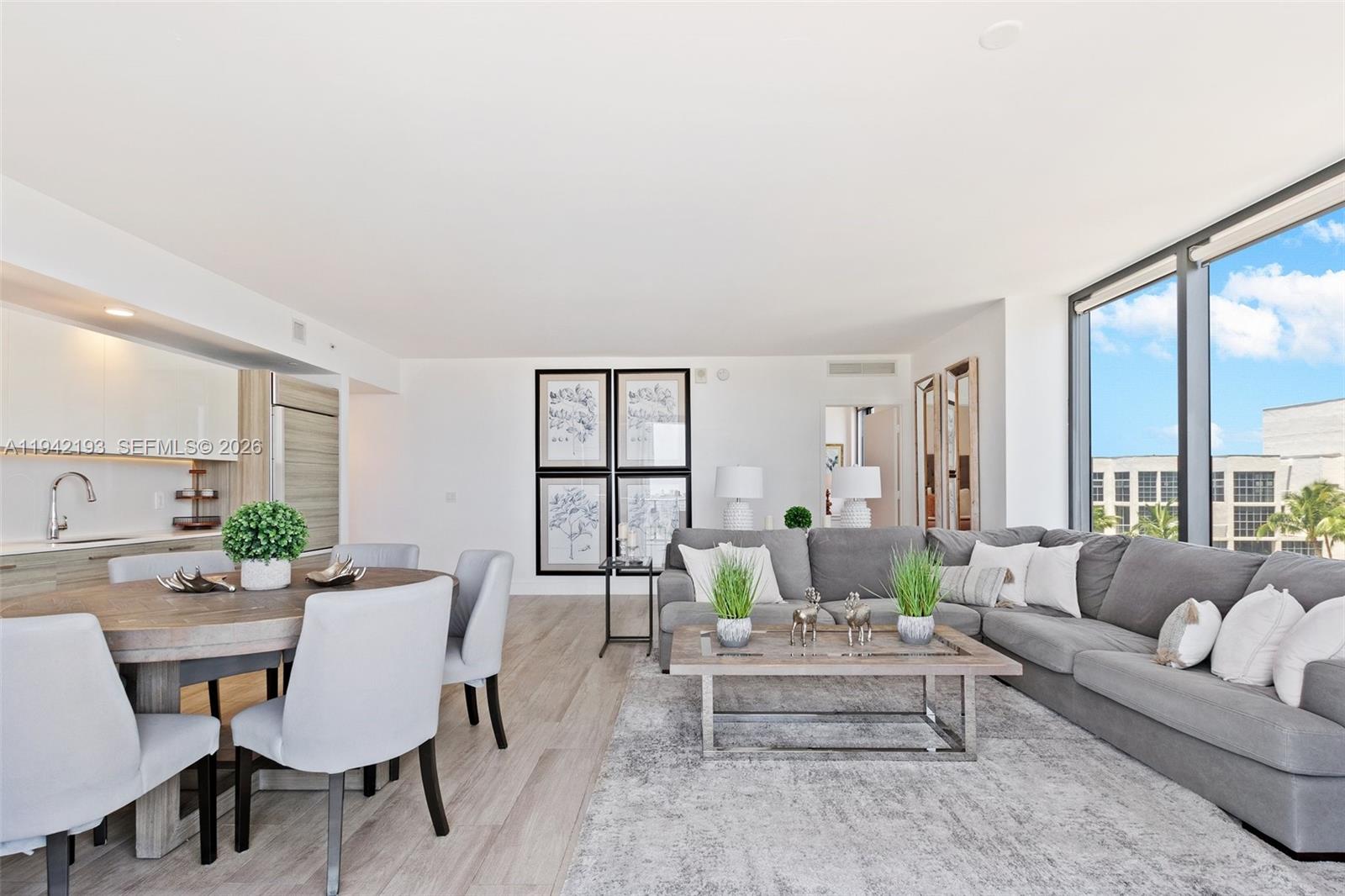 121 Northeast 34th Street, Unit 1008 Miami, FL 33137 - Photo 7 of 52 a living room with furniture and a large window