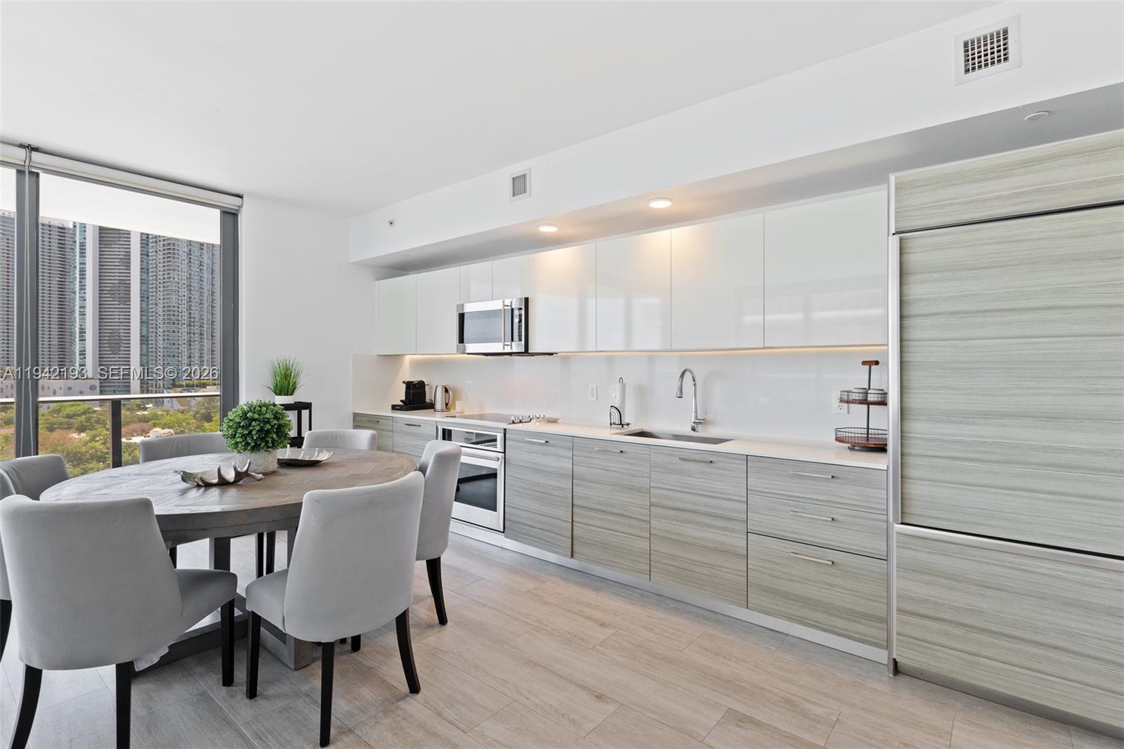 121 Northeast 34th Street, Unit 1008 Miami, FL 33137 - Photo 10 of 52 a view of a dining room with furniture and window