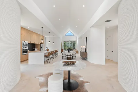 a living room with furniture a window and kitchen view