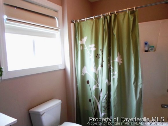 425 Lipscomb Road Angier, NC 27501 - Photo 9 of 12 a bathroom with a shower and a toilet