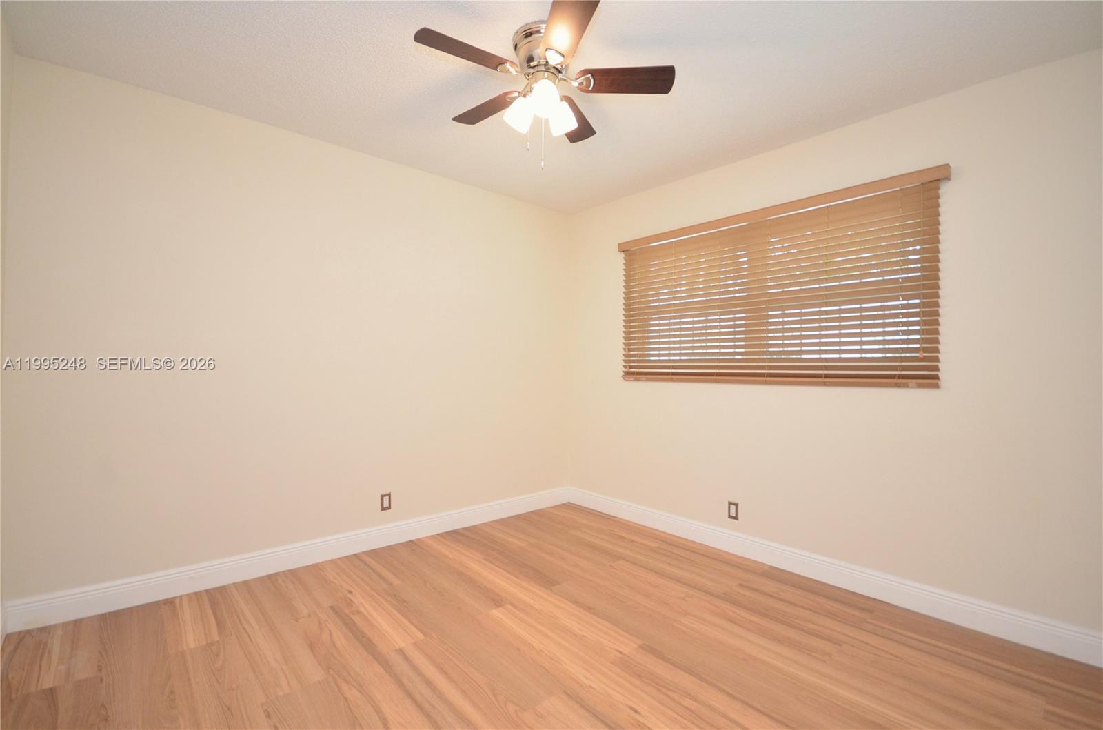 2430 Southwest 16th Street, Unit 2430 Miami, FL 33145 - Photo 13 of 18 a view of a room with wooden floor and a ceiling fan
