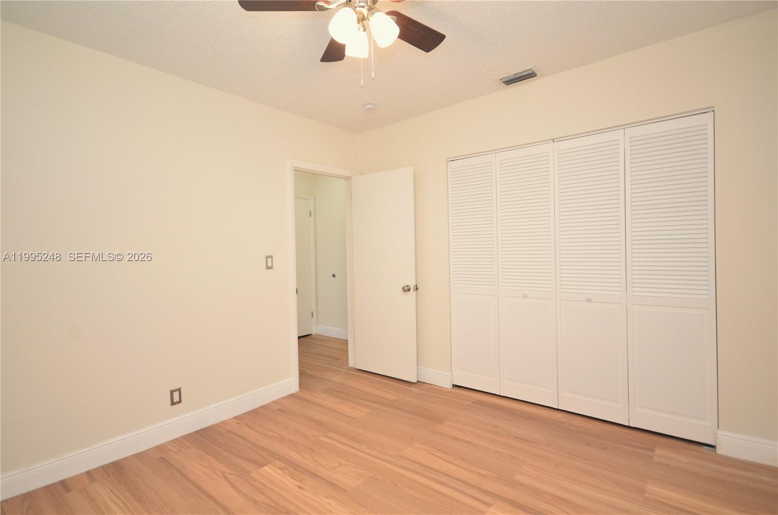 2430 Southwest 16th Street, Unit 2430 Miami, FL 33145 - Photo 14 of 18 an empty room with wooden floor and windows