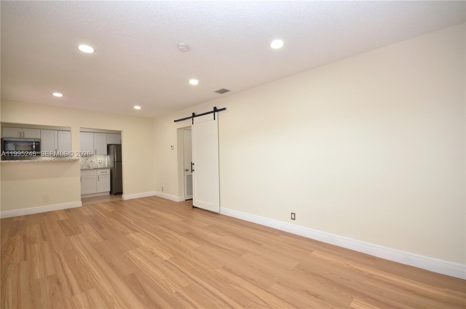 2430 Southwest 16th Street, Unit 2430 Miami, FL 33145 - Photo 3 of 18 a view of a kitchen with a sink and a refrigerator