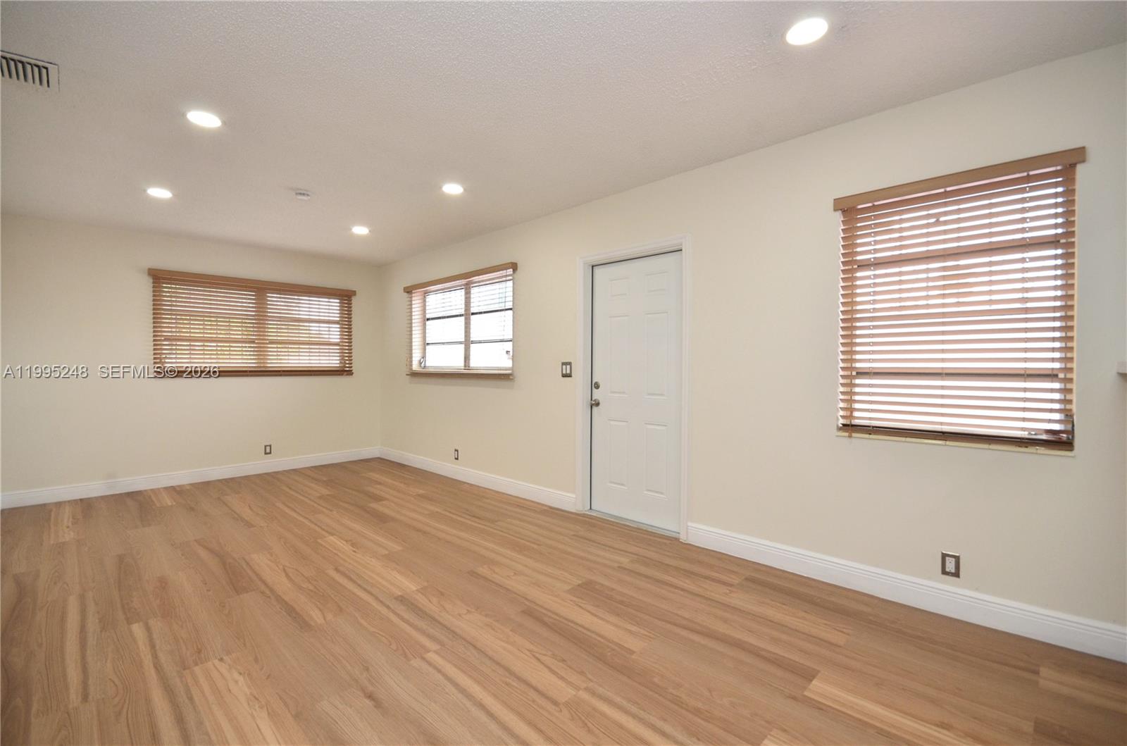2430 Southwest 16th Street, Unit 2430 Miami, FL 33145 - Photo 7 of 18 a view of empty room with wooden floor and fan