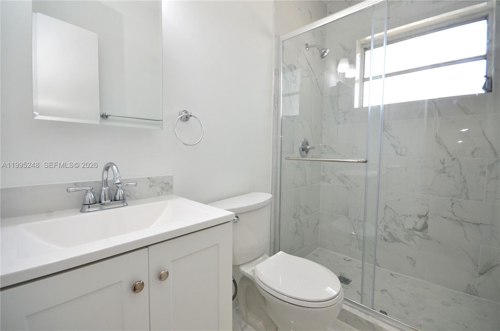 2430 Southwest 16th Street, Unit 2430 Miami, FL 33145 - Photo 8 of 18 a bathroom with a sink a toilet and shower