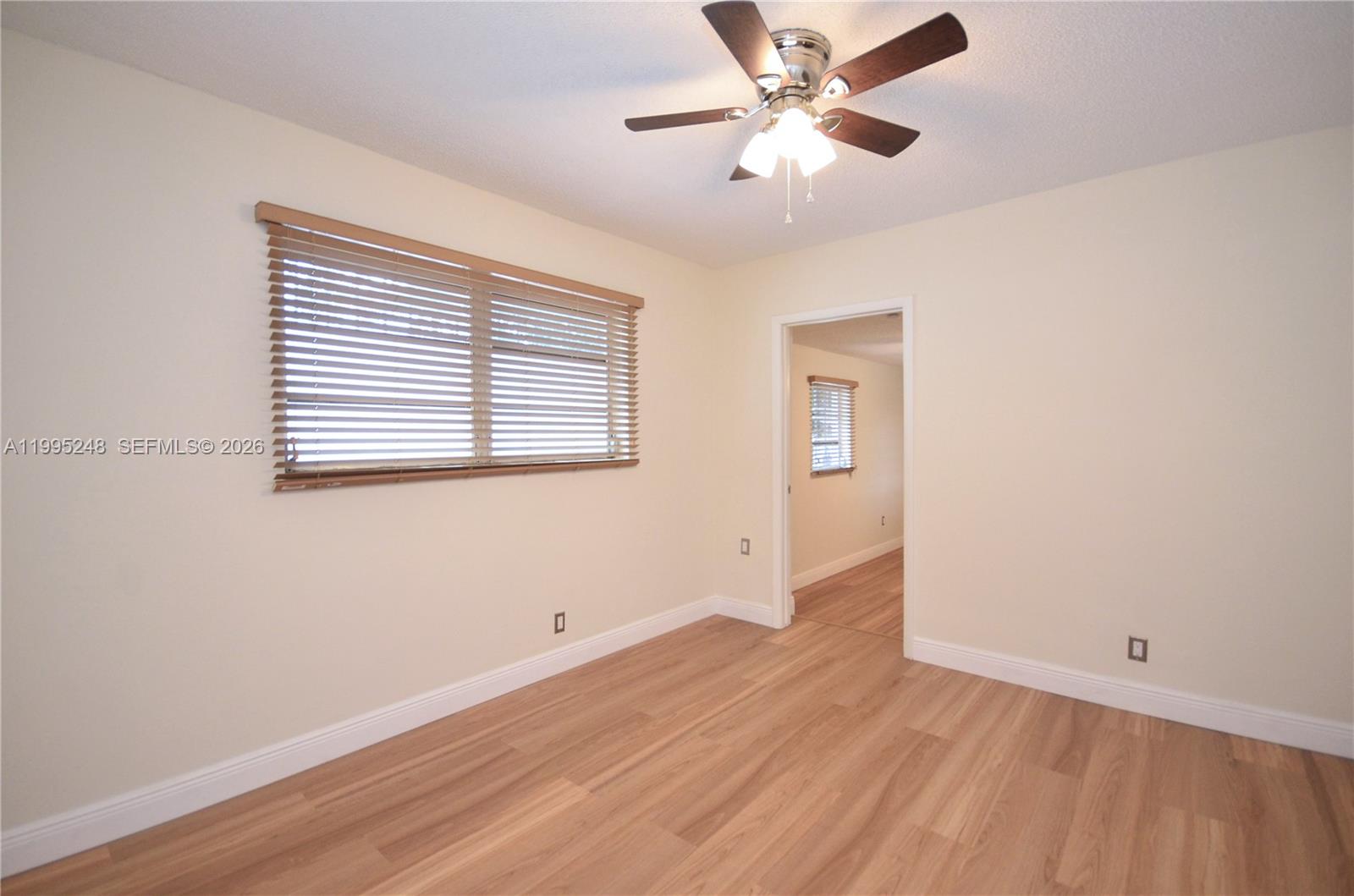 2430 Southwest 16th Street, Unit 2430 Miami, FL 33145 - Photo 9 of 18 a view of empty room with wooden floor and fan