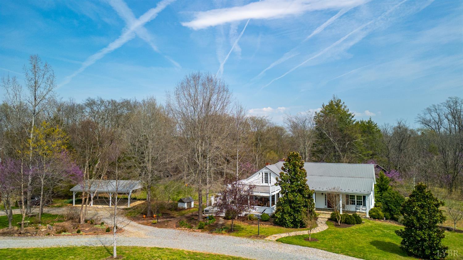 a front view of a house with a yard and mountain view