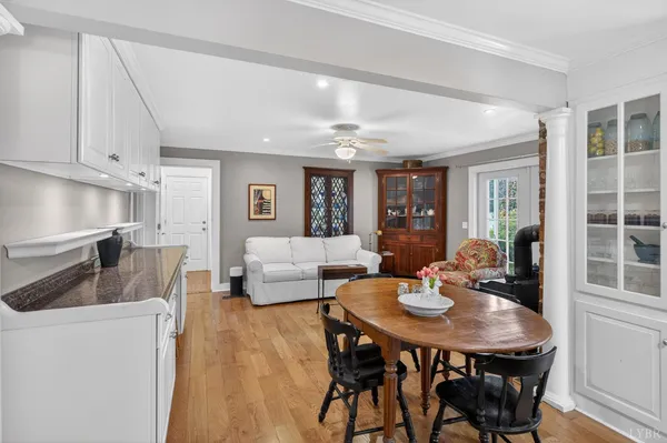 a kitchen with kitchen island granite countertop a sink and white cabinets