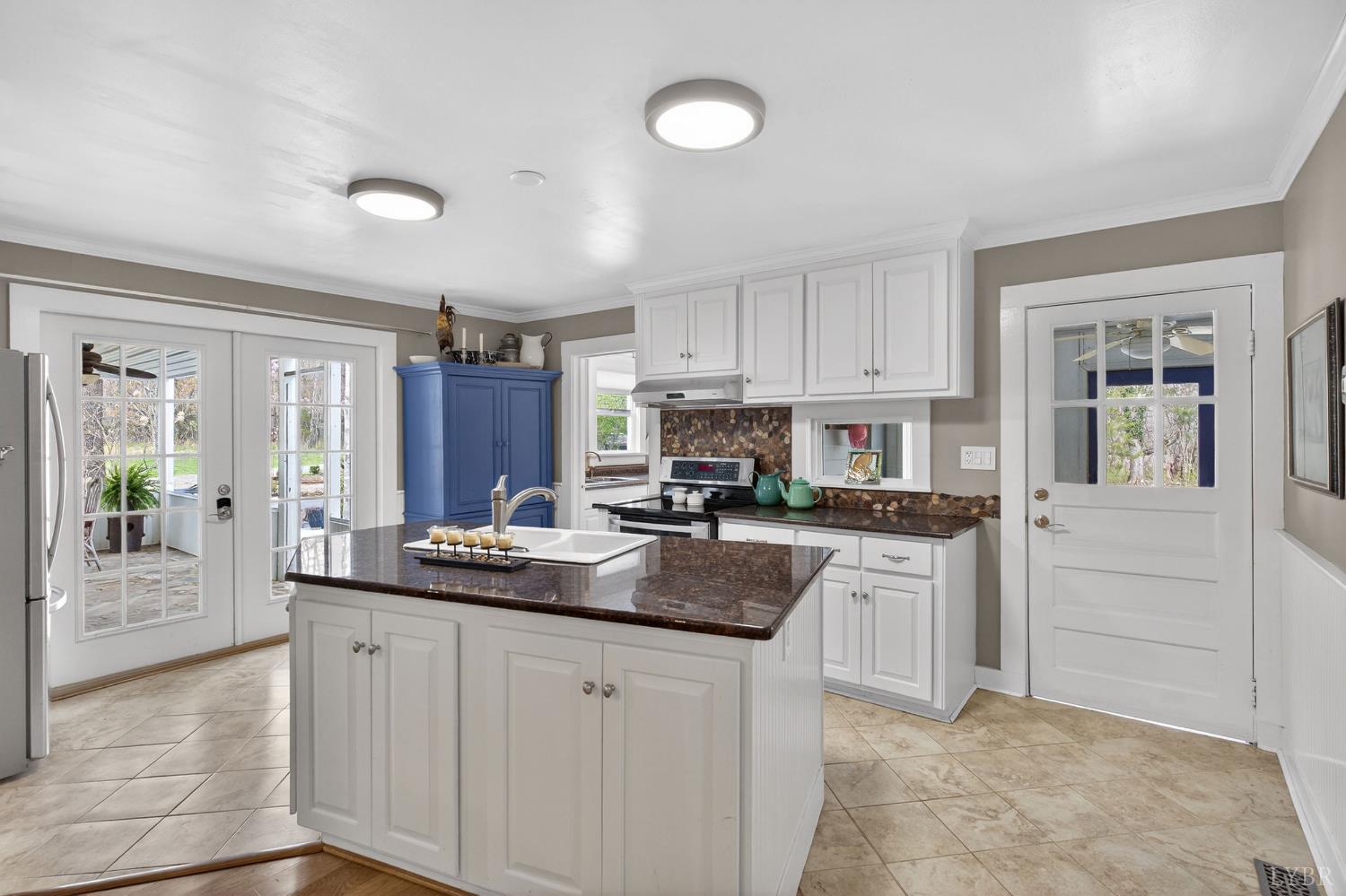 3805 Whipping Creek Road Gladys, VA 24554 - Photo 22 of 96 a kitchen with kitchen island granite countertop a sink and white cabinets