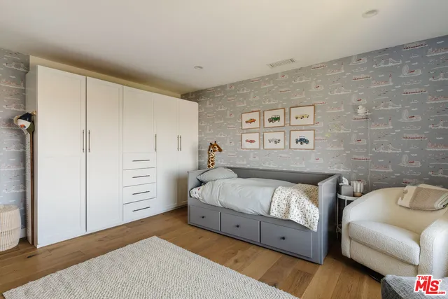 a bedroom with a bed and a couch