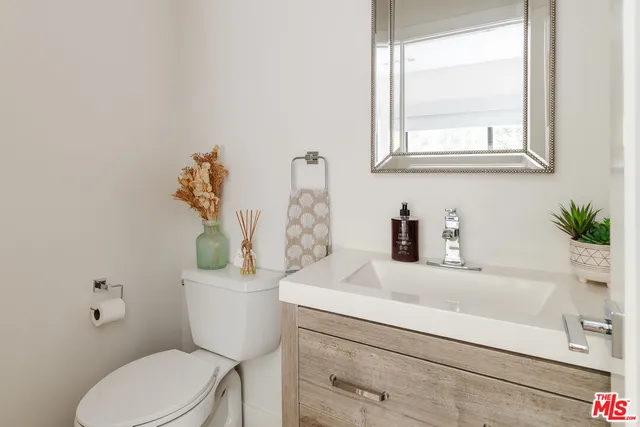 a bathroom with a sink a toilet and a window