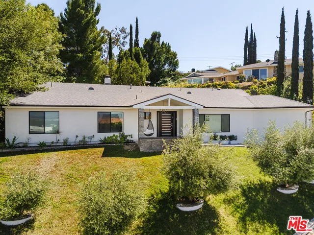 a aerial view of a house with swimming pool garden and patio